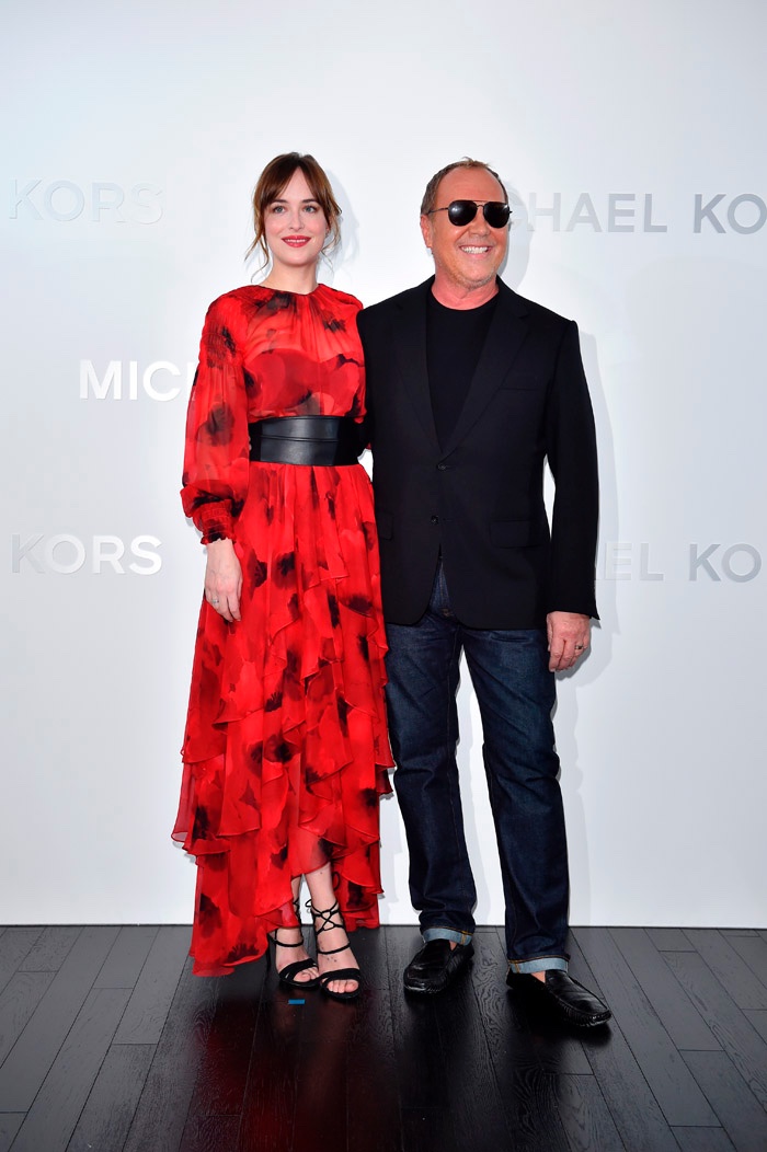 NOVEMBER 2015 - Dakota Johnson at Michael Kors Ginza store opening in Japan wearing red poppy print dress. Photo: Michael Kors / Getty Images