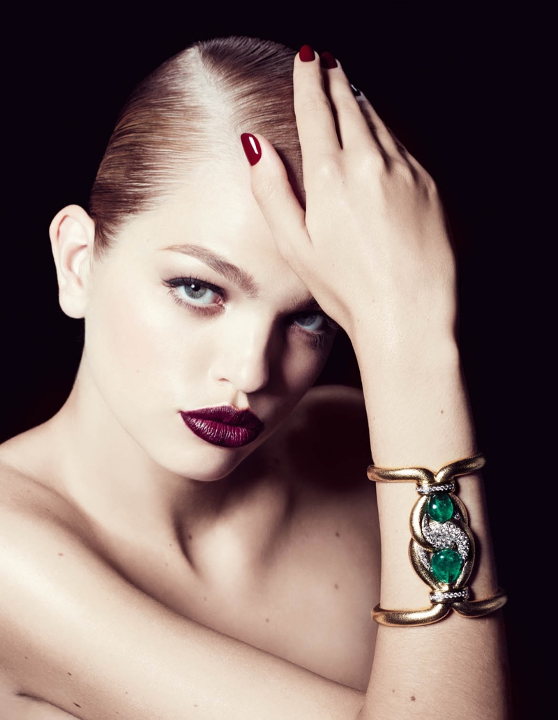 The model wears jewelry for the editorial