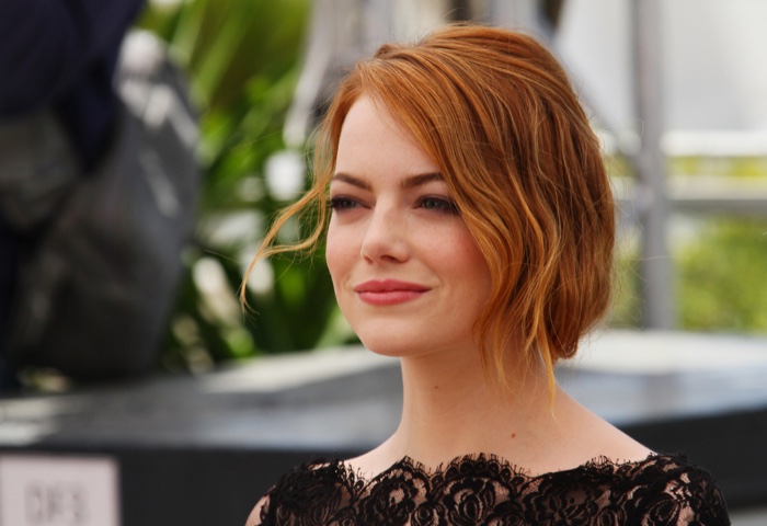 Emma Stone shows off a chic wavy updo for medium length hair. Photo: Denis Makarenko / Shutterstock.com 