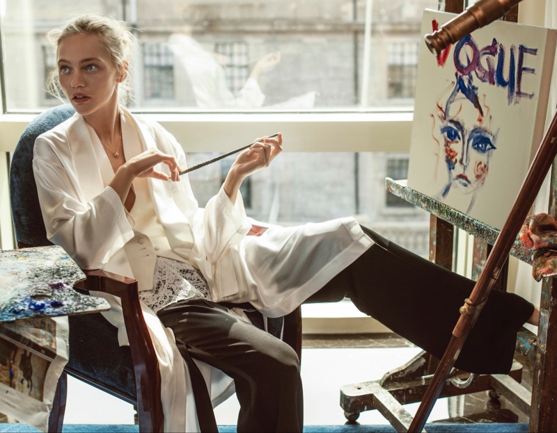 PAINTING BEAUTY: Sasha Pivovarova poses next to her artwork in white vest and black trousers