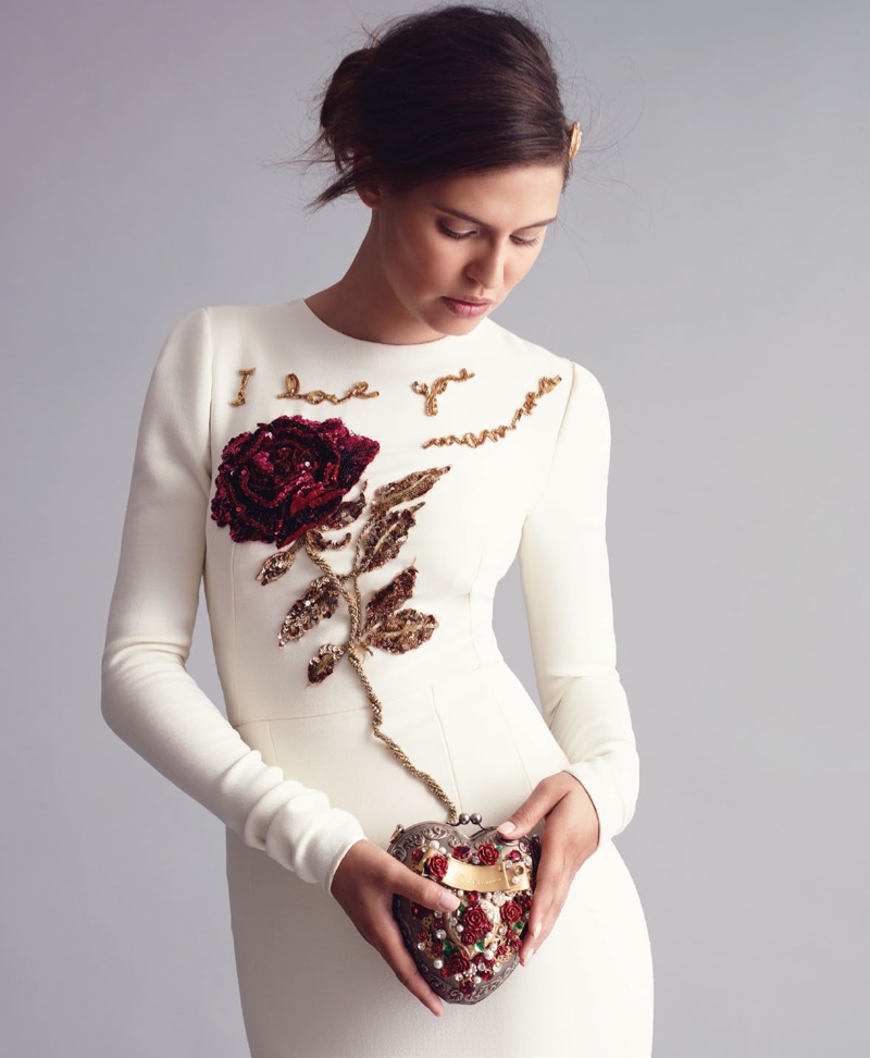 Bianca Balti models white long-sleeve dress with rose embroidery