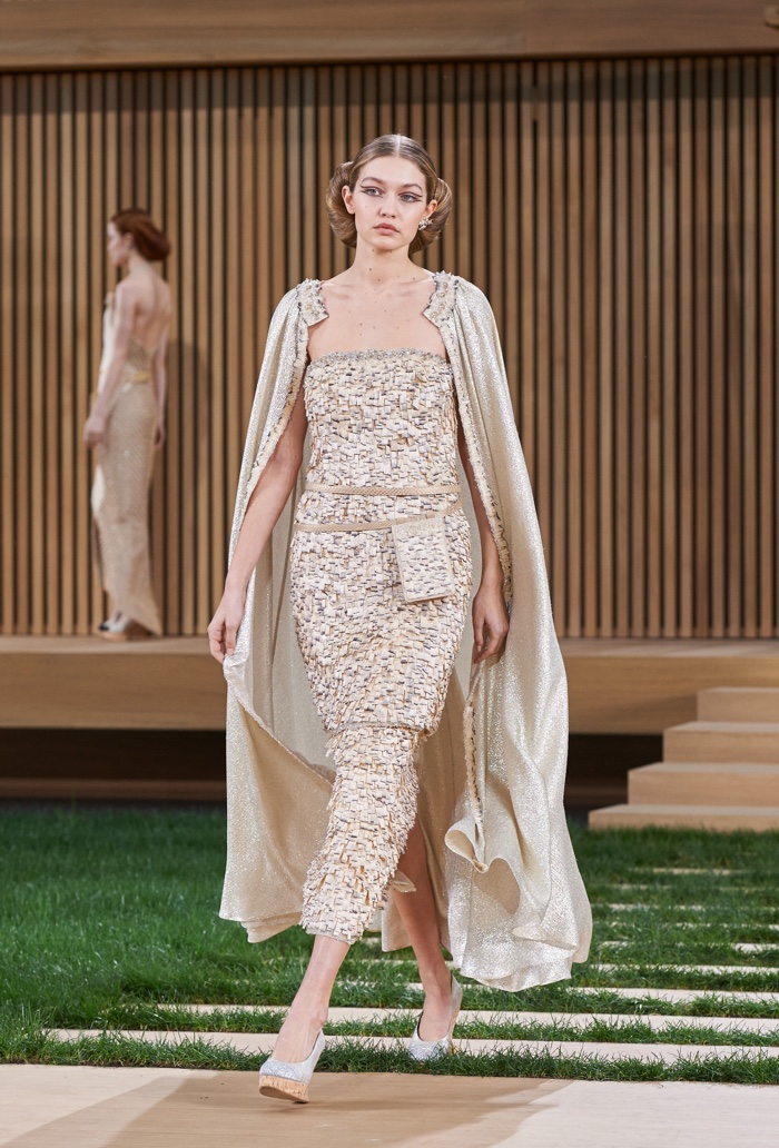 Gigi Hadid walks the runway at Chanel's spring 2016 haute couture show wearing a cape and embroidered dress
