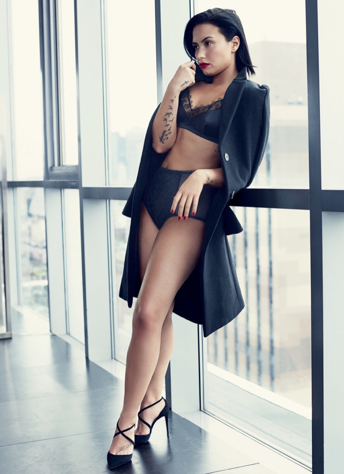 The singer poses in a black jacket and lingerie look