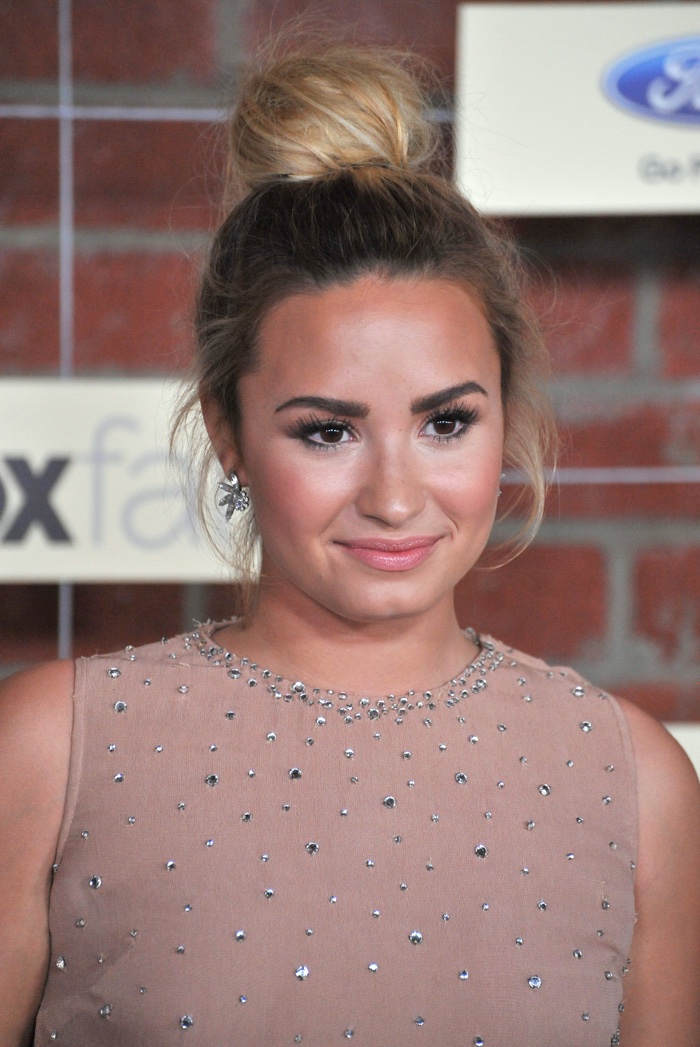 Demi Lovato also wore her hair in a top knot hairstyle in 2012 as a blonde. Photo: Featureflash / Shutterstock.com