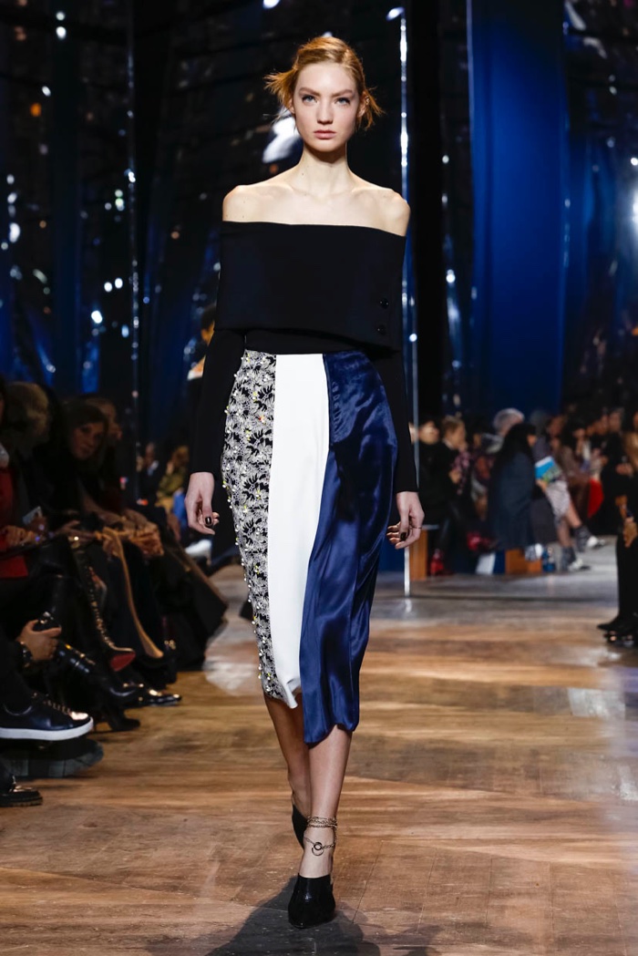 A model walks Dior's spring 2016 haute couture show in off the shoulder top and paneled skirt