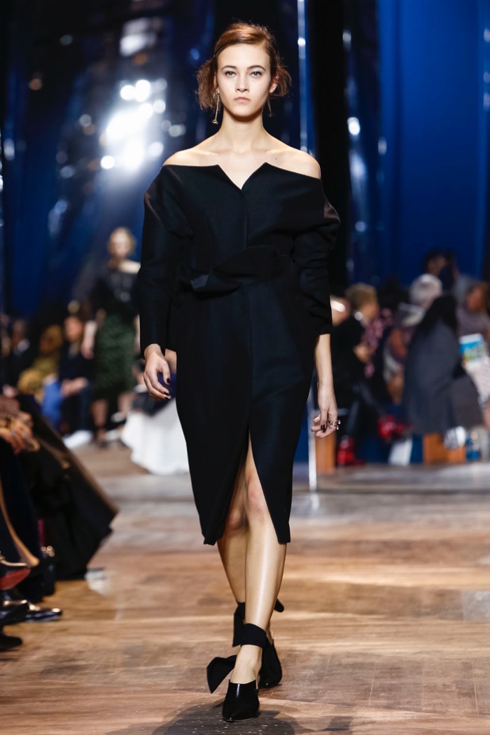 A model walks Dior's spring 2016 haute couture show in off the shoulder black dress