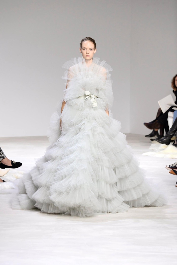 A model wears an empire waist gown with tiered pleating at Giambattista Valli's spring 2016 haute couture show