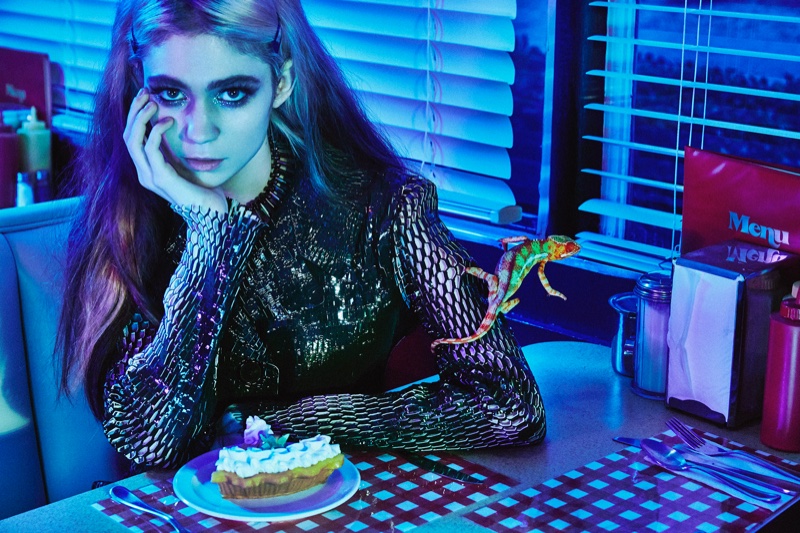 Grimes poses in patent leather coat by Dior