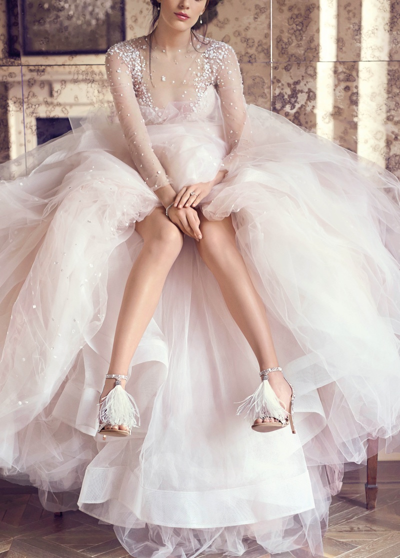 Footwear brand Jimmy Choo shared a look at its 2016 bridal collection featuring silver and white styles. Pictured: Jimmy Choo Viola White Suede and Hot Fix Crystal Embellished Sandals with an Ostrich Feather Tassel