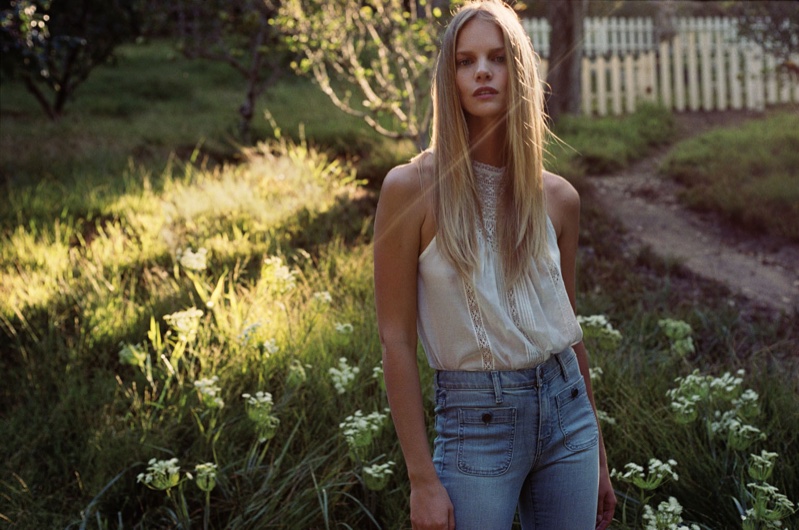 Posing in a lace top and denim pants, Marloes wears a look from Joie's spring 2016 collection