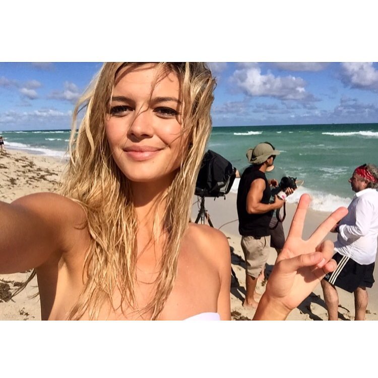 Kelly Rohrbach takes a selfie on the beach while shooting Calzedonia campaign