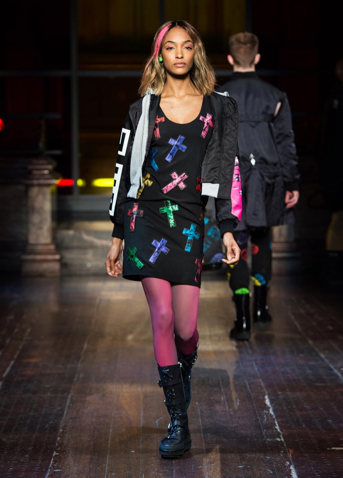 PRETTY IN PUNK: Jourdan Dunn walks the runway at Moschino's fall-winter 2016 show wearing a cross embellished shift dress and bomber jacket with combat boots.