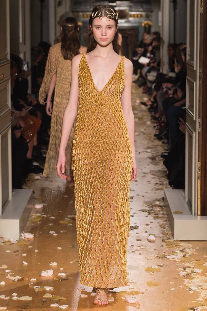 A model walks the runway at Valentino's spring 2016 haute couture collection wearing a macrame dress of velvet and burnished gold