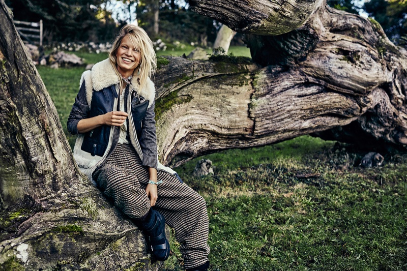 The model poses in a shearling jacket with baggy trousers