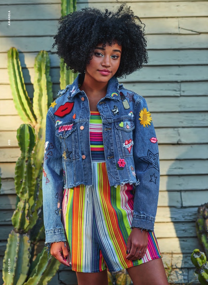 Amandla poses in customized denim jacket and rainbow romper from ASOS