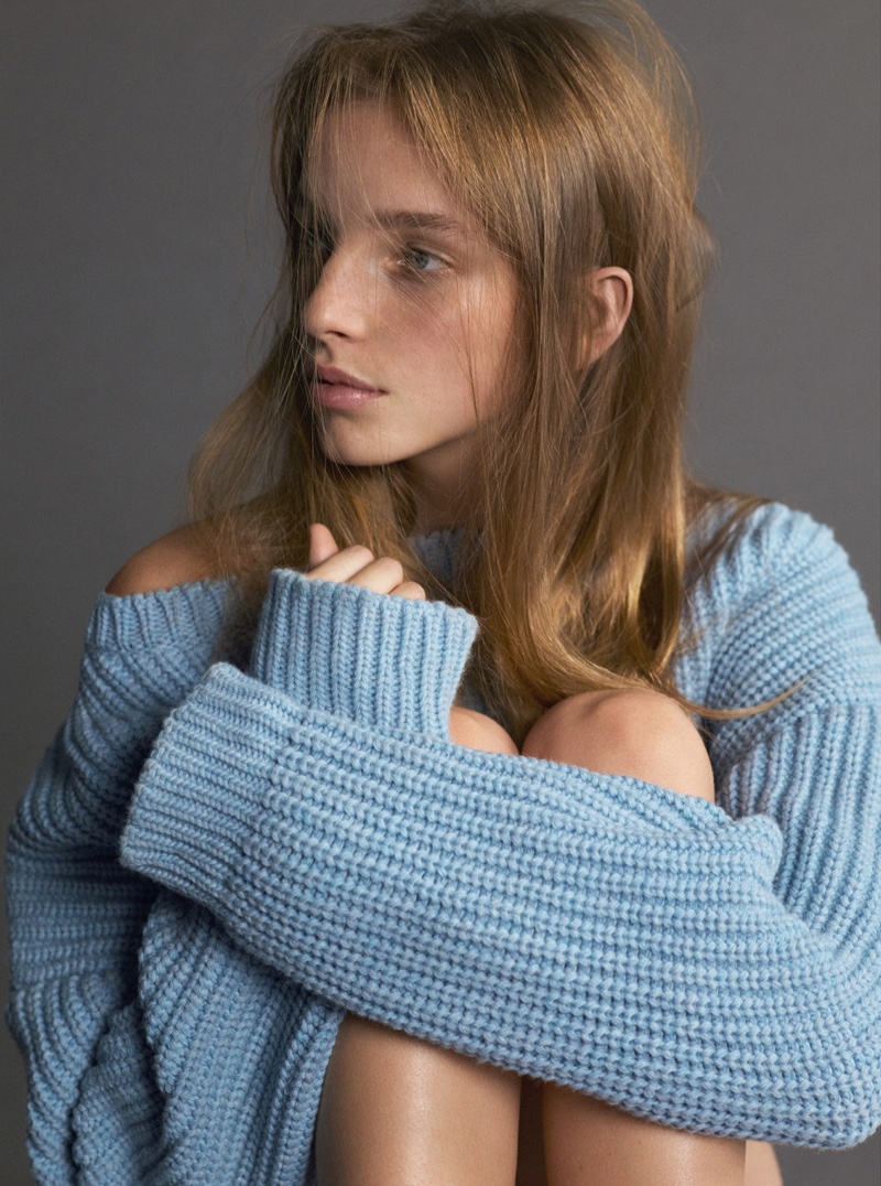 Model wears blue Dior wool sweater