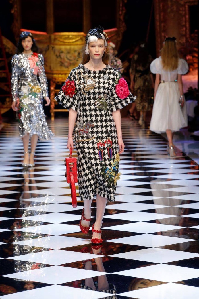A model wears a houndstooth print dress with floral imagery at Dolce & Gabbana's fall-winter 2016 show