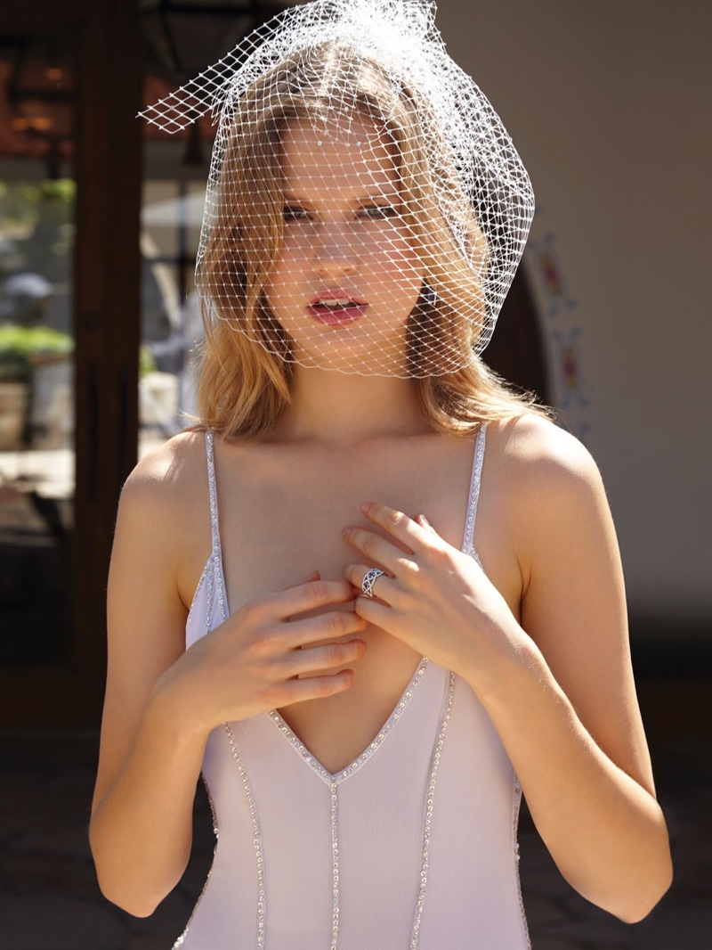 Elisabeth models a v-neck dress with wedding veil