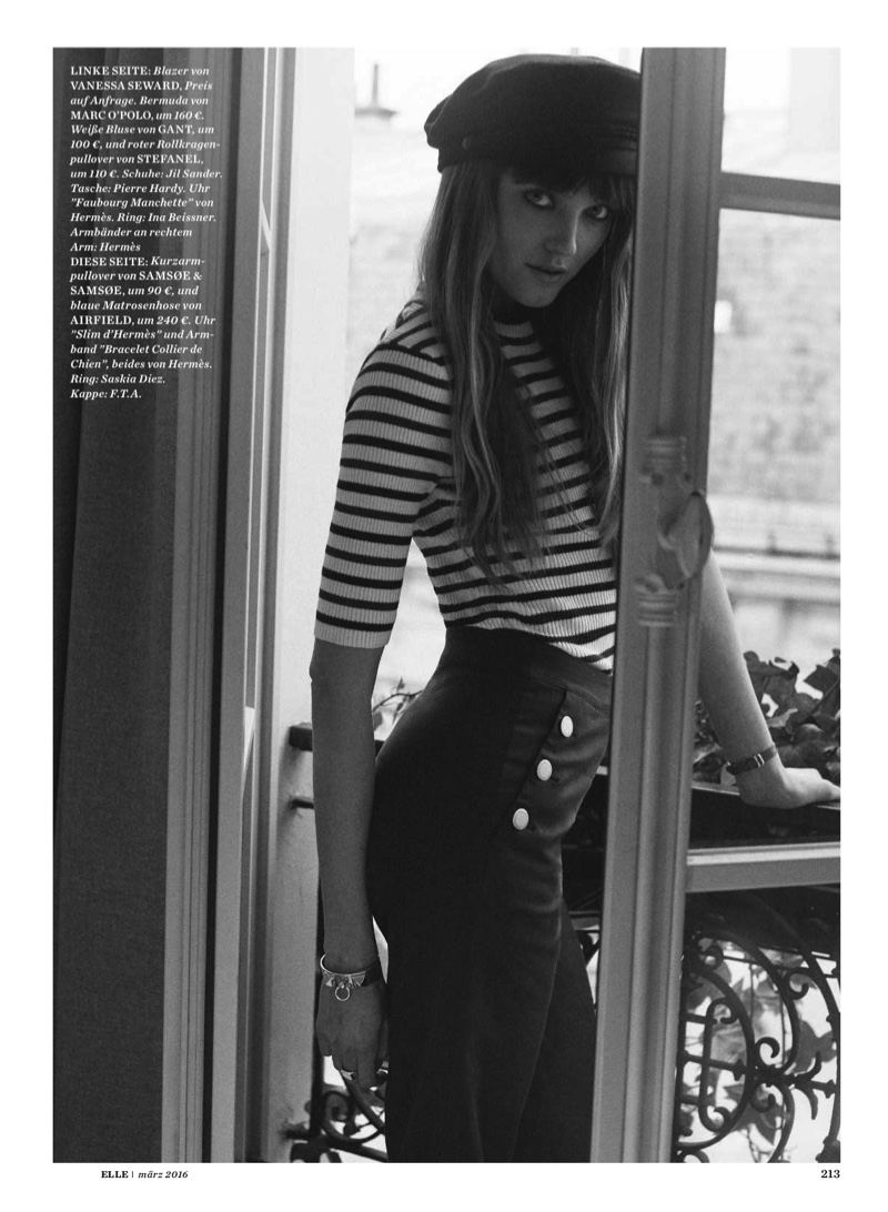Vlada poses in high-waisted trousers, a striped shirt and beret