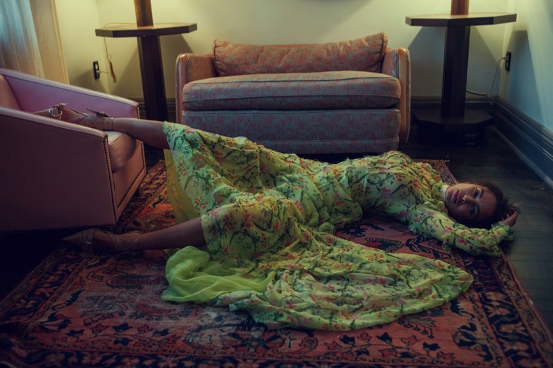 Irina lounges in an Erdem maxi dress with floral print