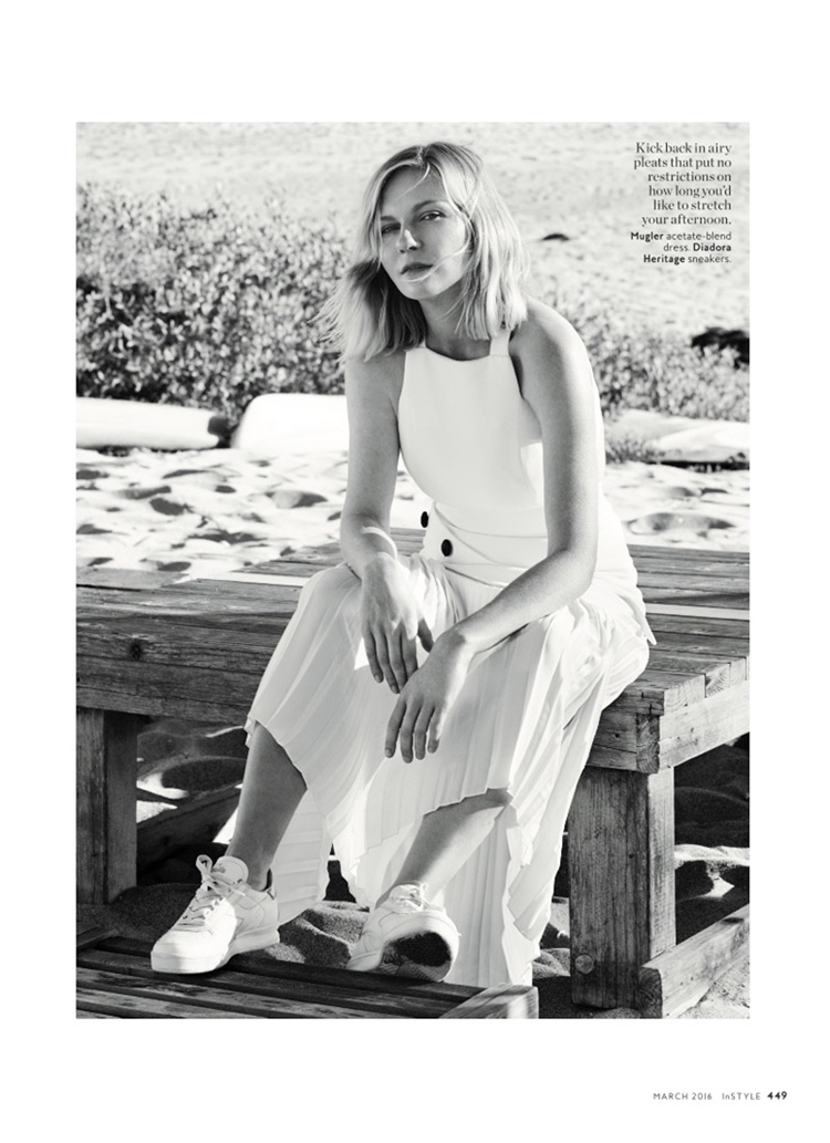 Kirsten poses on the beach wearing a white Mugler dress