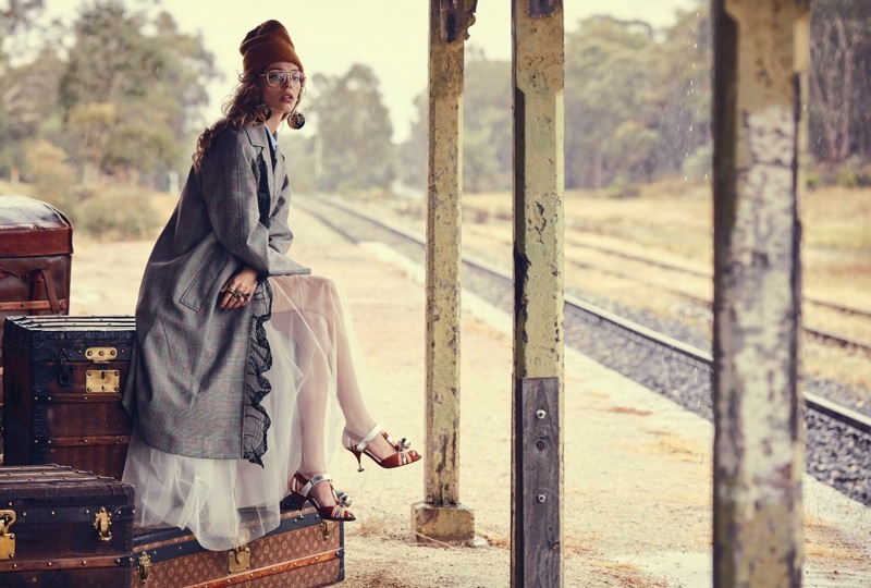 Photographed near train tracks, Ondria poses in a Miu Miu coat