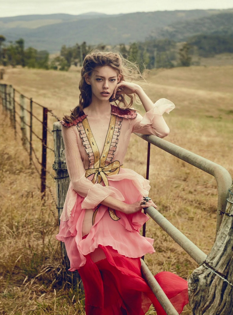 Ondria poses in field with a Gucci dress