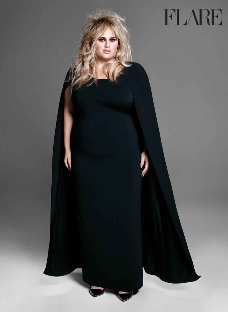 Rebel Wilson poses in black cape and gown