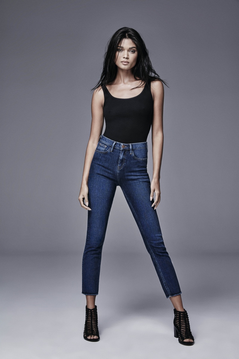Photographed in a black tank and high waist jeans, Daniela Braga poses for River Island's spring 2016 denim campaign