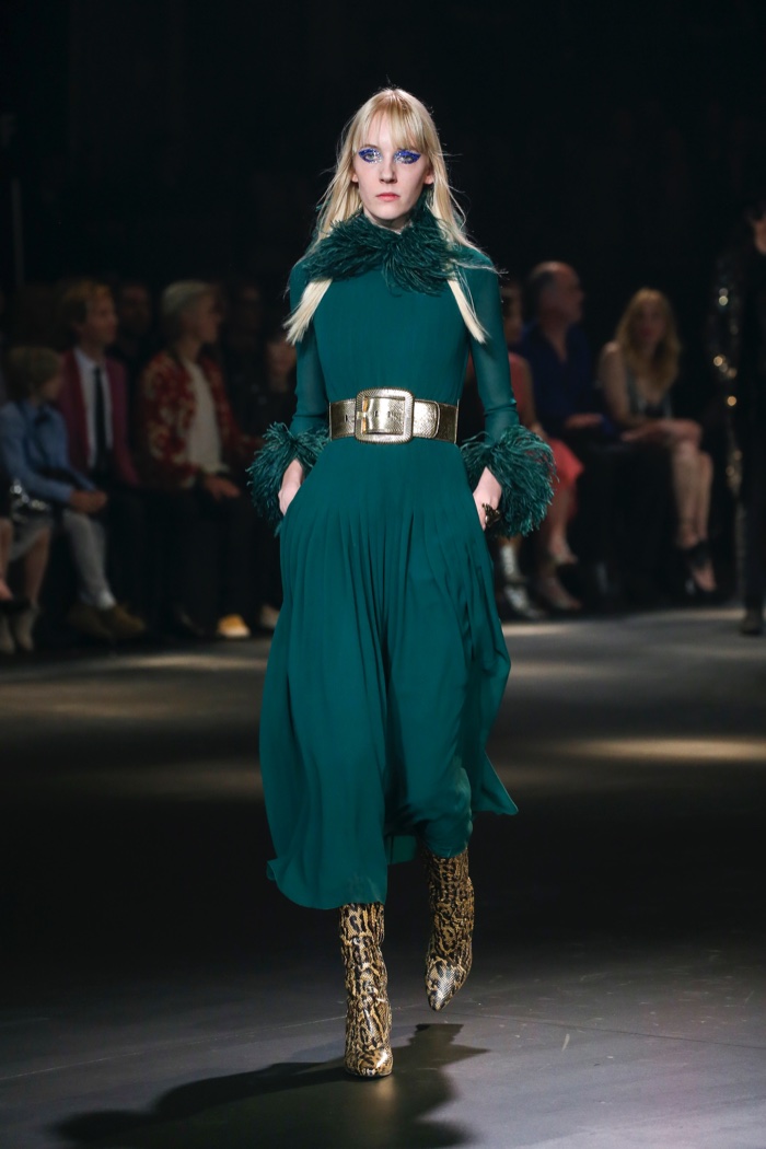 Model wears long-sleeve green maxi dress with wide gold belt at Saint Laurent's fall 2016 runway show