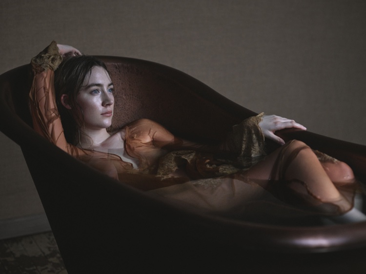 Saoirse Ronan poses in a tub filled with water in Rosamosario gown