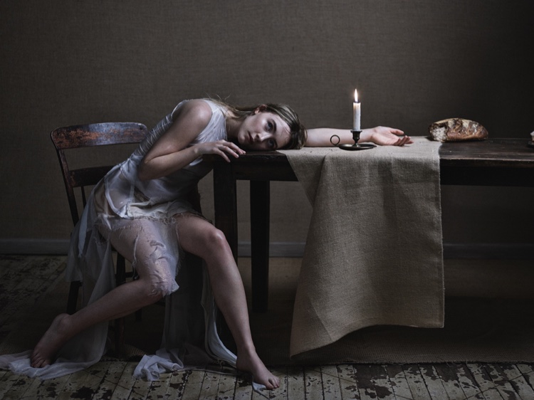 Posing next to a table setting, Saoirse dons a Marques ' Almeida dress