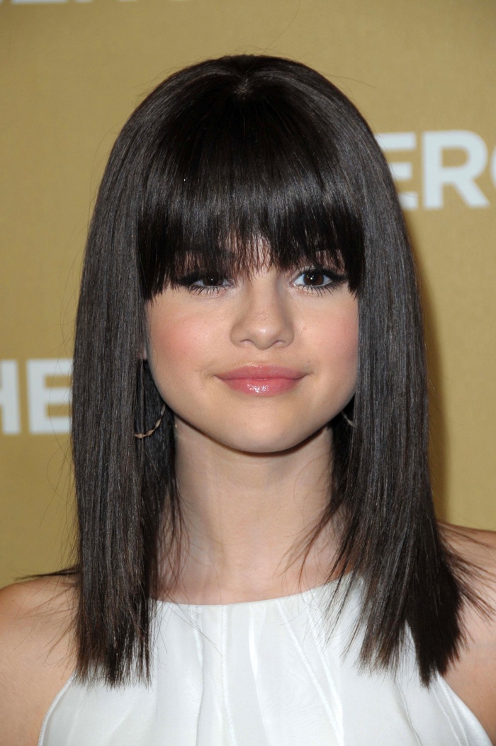 At the 2008 CNN Heroes event, Selena Gomez debuted blunt bangs with a straight medium length haircut. Photo: s_bukley / Shutterstock.com