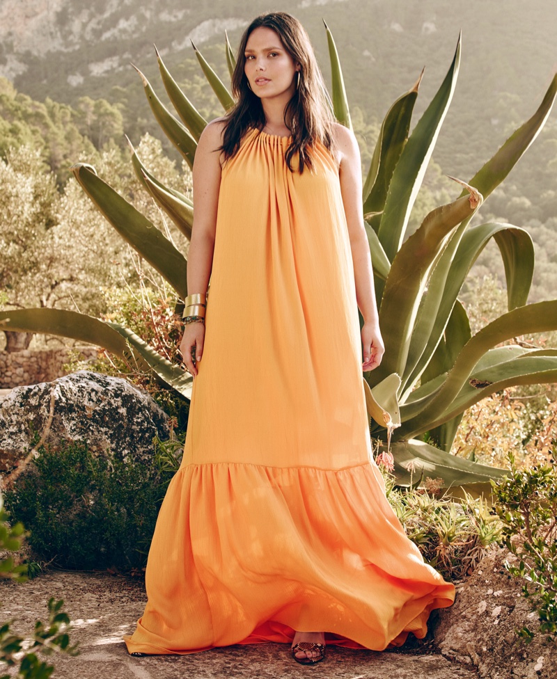 Candice Huffine models an orange maxi dress by Violeta x Mango