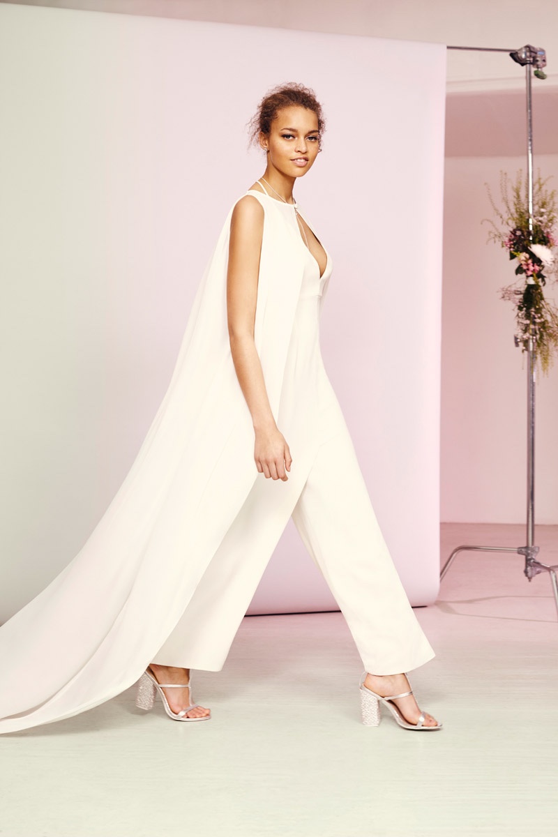 Model wears ASOS Bridal Jumpsuit & Cape