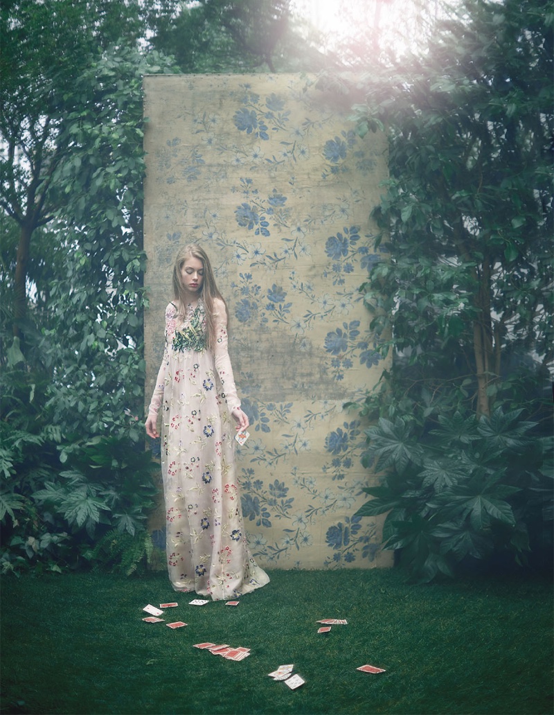 Surrounded by green shrubbery, Lauren models a long-sleeve Giambattista Valli gown embellished with florals