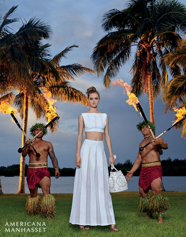 Lindsey Wixson poses next to Hawaiian flame throwers in a Giorgio Armani crop top and skirt