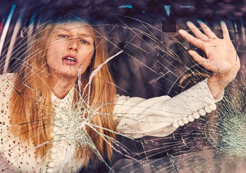 Next to shattered glass, the blonde model gazes into the camera's lens in a Proenza Schouler blouse