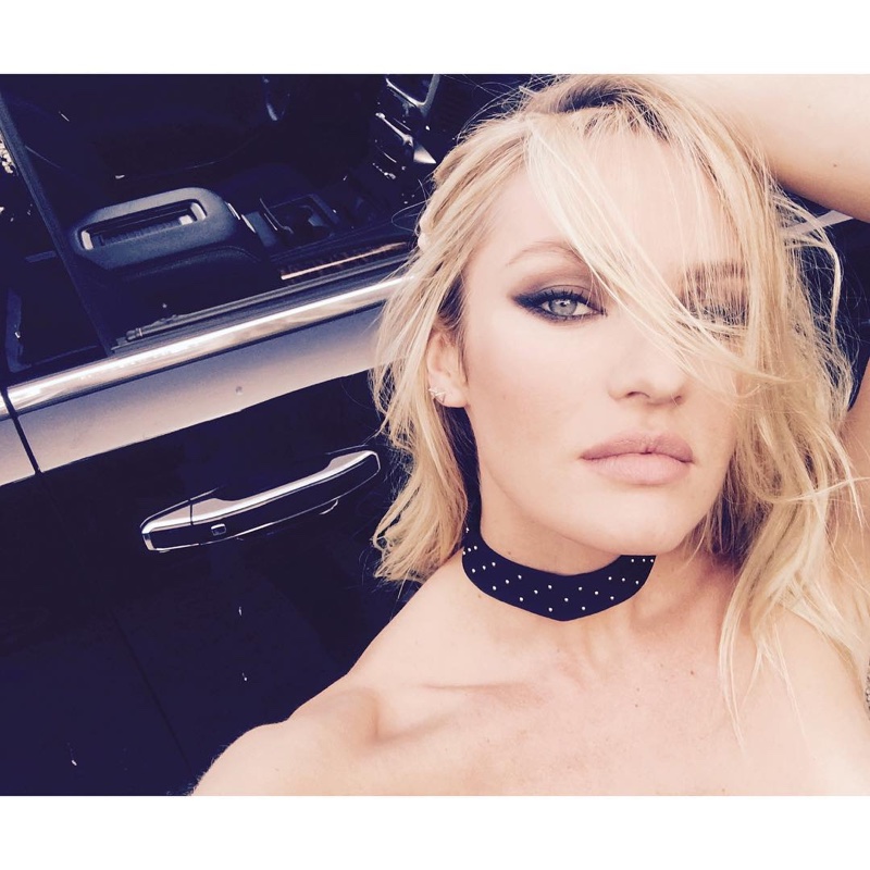 Candice Swanepoel shares a behind the scenes photo from an upcoming shoot wearing a choker necklace