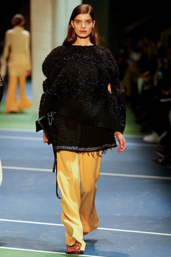A model walks the runway at Celine's fall-winter 2016 show wearing an oversized sweater and wide-legged trousers
