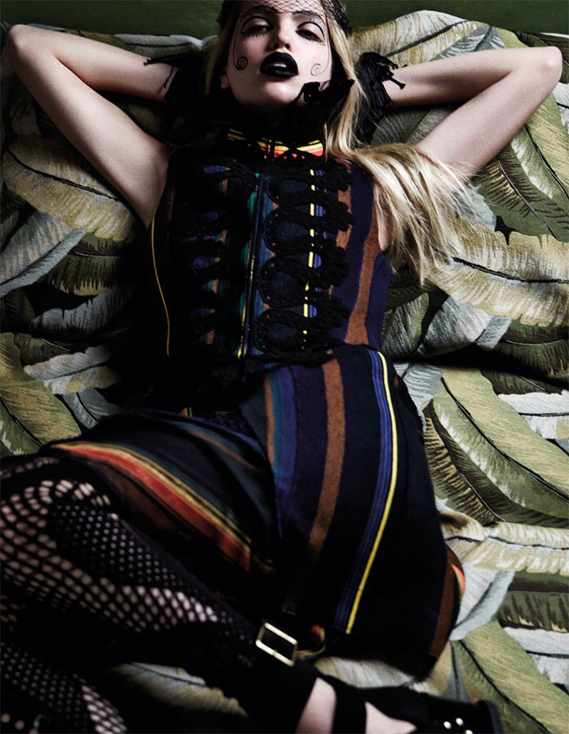 Captured by David Roemer, Daphne Groeneveld lounges in a striped dress and painted makeup