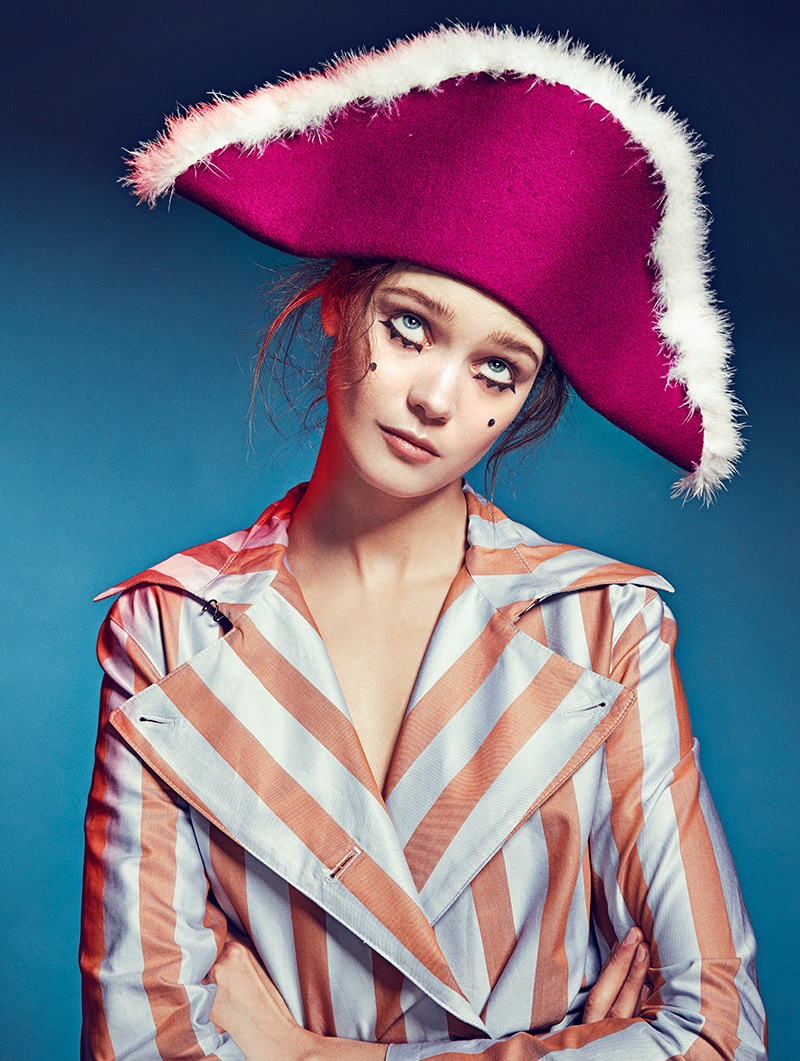 Wearing a whimsical look, Diana Moldovan poses in a tricorn hat with striped jacket