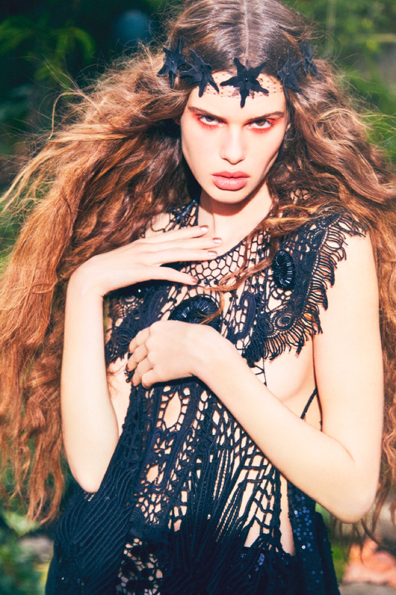 Zoi models a black macrame top and star embellished headband