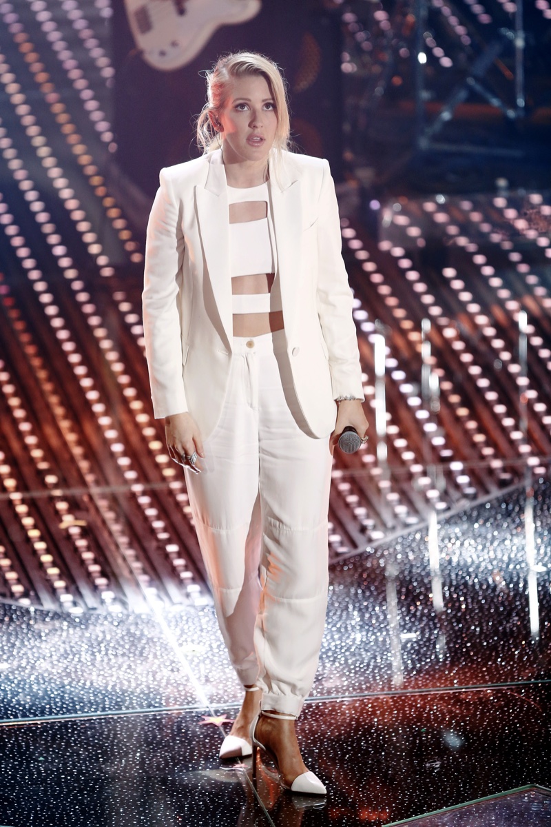 FEBRUARY 2016: Ellie Goulding performs at the 2016 Sanremo Italian Song's Festival wearing a white pantsuit with cut-out top. Photo: Andrea Raffin / Shutterstock.com