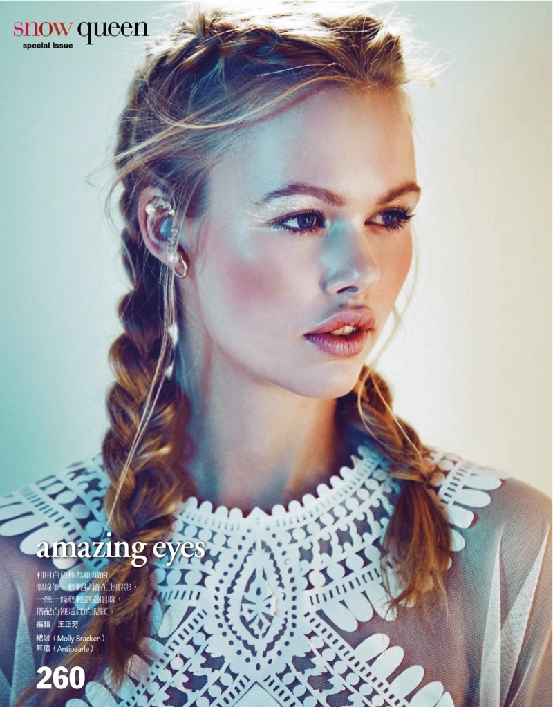 The model wears fishtail braids for the beauty editorial