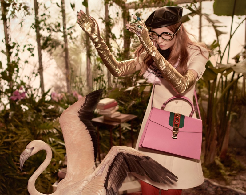 Starring in Gucci’s pre-fall 2016 campaign, Polina Oganicheva poses in a wool-silk dress, gold fingerless gloves and Sylvie bag