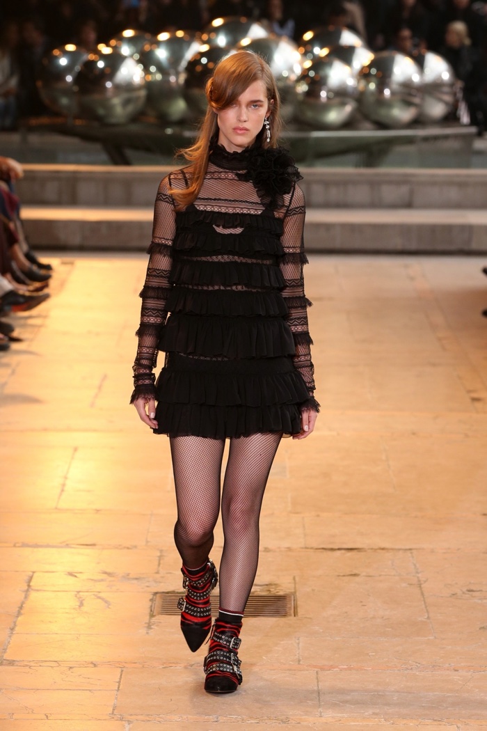 A model walks the runway at Isabel Marant's fall-winter 2016 show wearing a black dress with ruffles