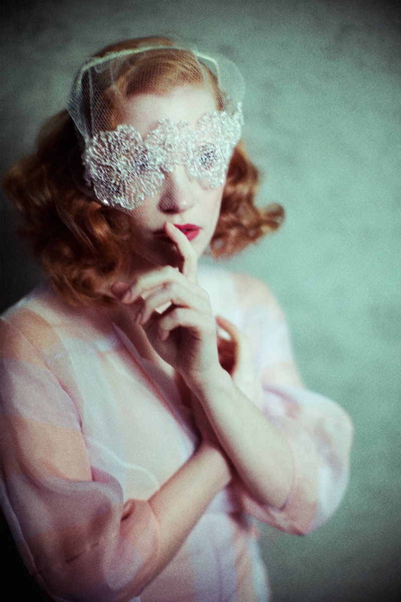 Jessica Chastain poses in white lace mask and Dior silk organza dress