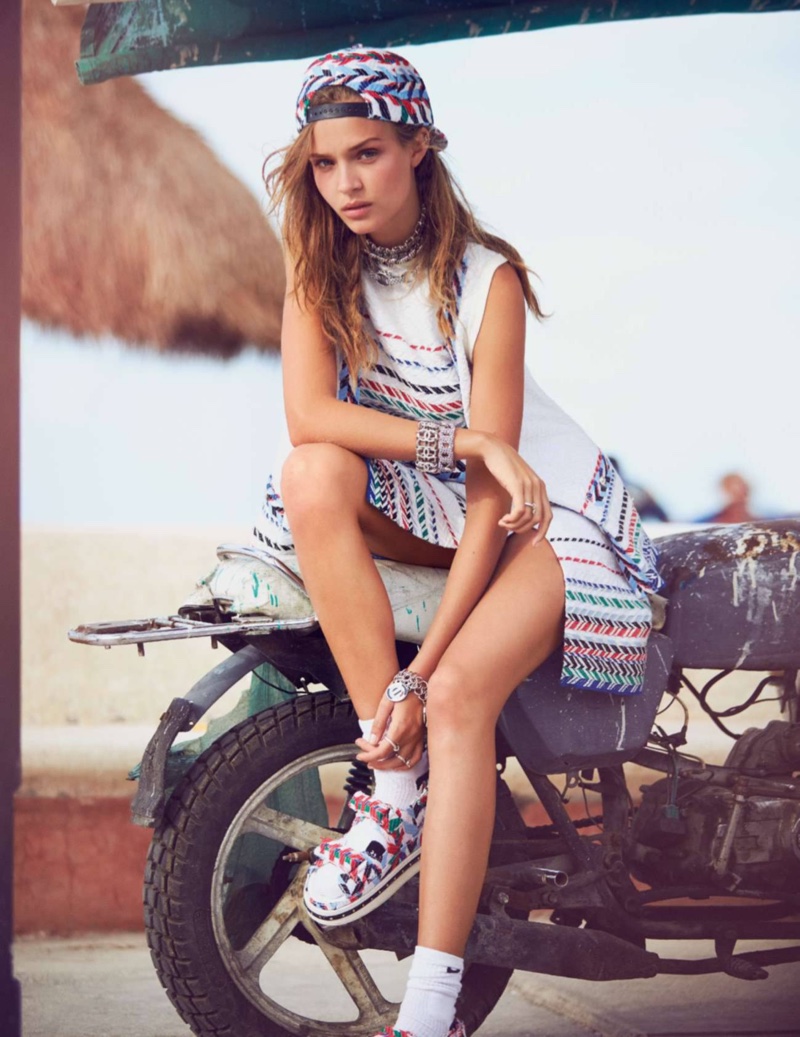 Posing on a bike, Josephine Skriver goes casual in head to toe Chanel including a printed baseball cap and sandals