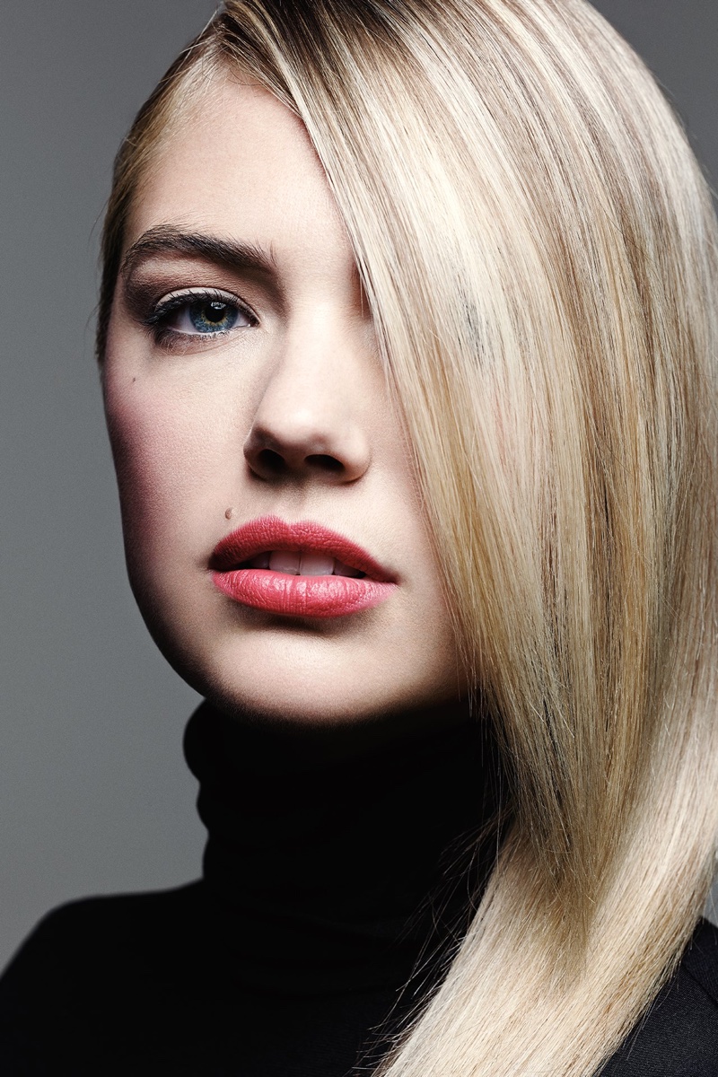 Posing with a berry red lip and hair parted to the side, Kate Upton stuns in the photo spread